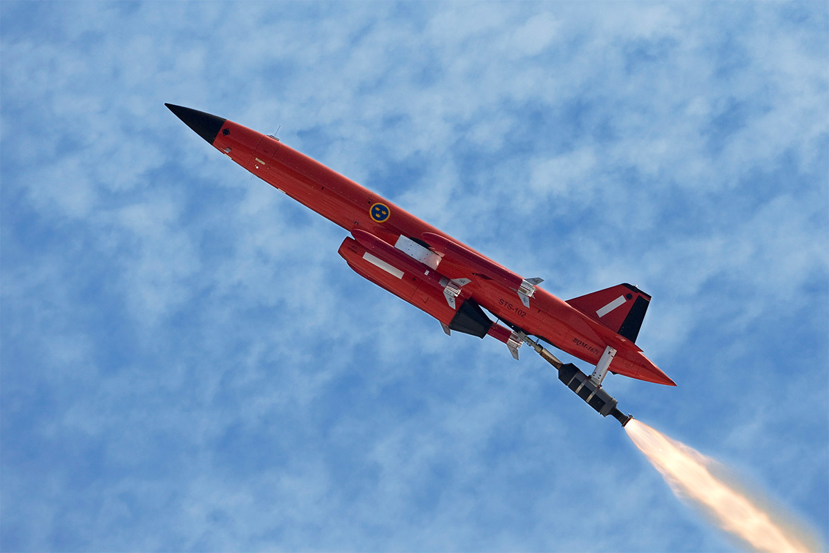 An orange coloured target drone BQM167i in the air