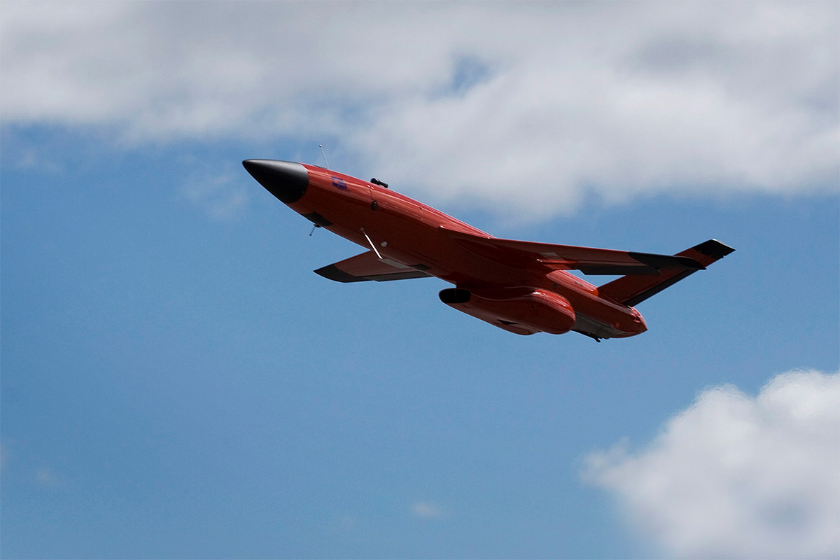 An orange coloured target drone FireJet in the air